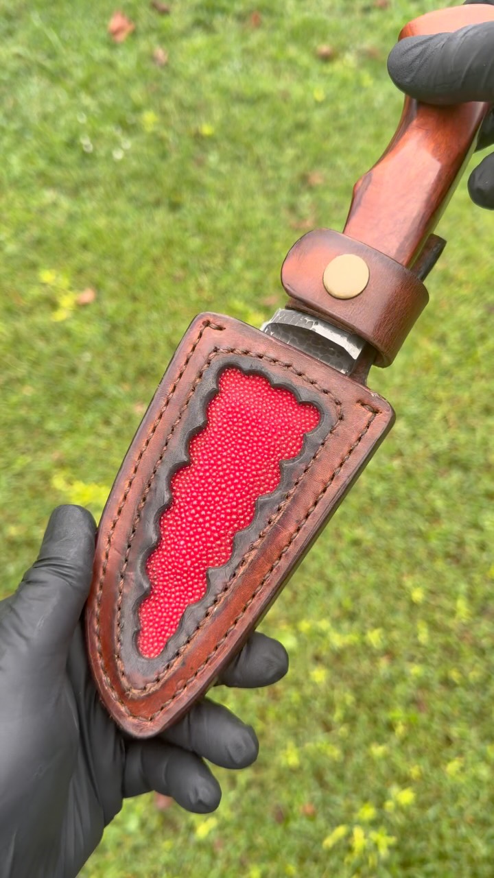 Josh's reddish-brown handled knife in a stitched leather sheath with a vivid red ray-skin insert